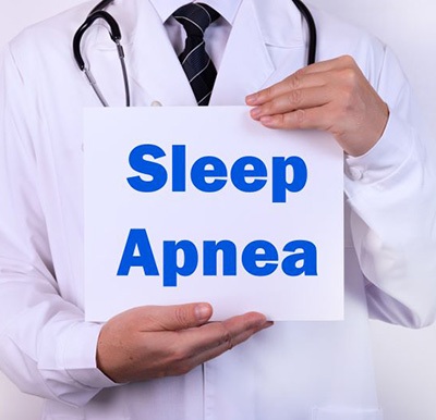 Doctor holding sign that says “sleep apnea”