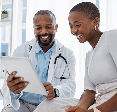 Doctor and patient looking at tablet together