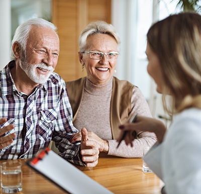 a couple speaking with their sleep dentist about getting treatment