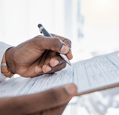 a healthcare provider looking over a patient’s forms