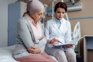 Female cancer patient talking with doctor